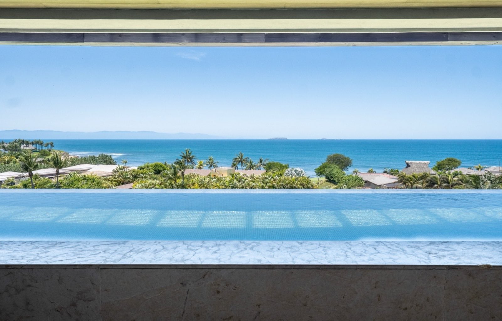 Condo Tau 131 pool edge overlooking palms and the ocean — Punta Mita Nayarit, Mexico