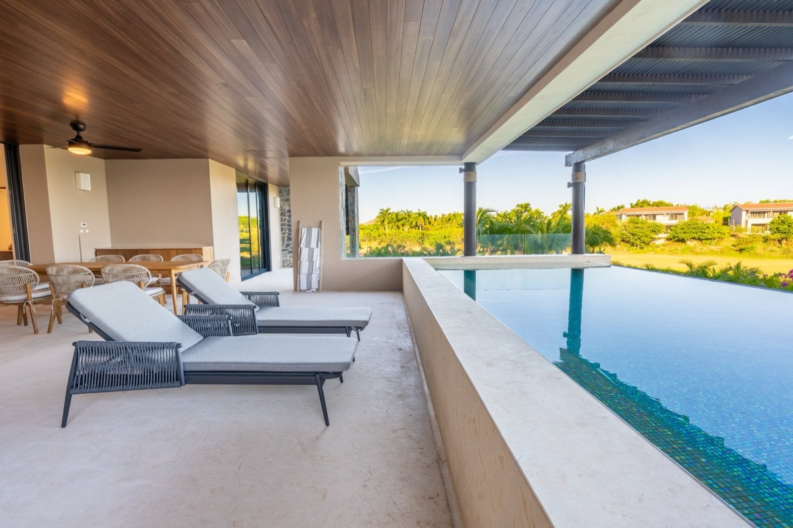 Condo Tau 612 covered pool terrace with loungers beside the water — Punta Mita Nayarit, Mexico