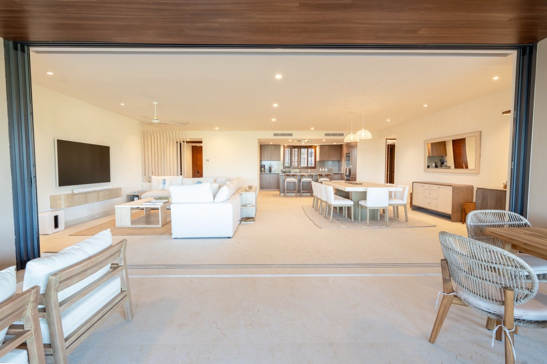 Condo Tau 612 living and dining area seen through open terrace doors — Punta Mita Nayarit, Mexico