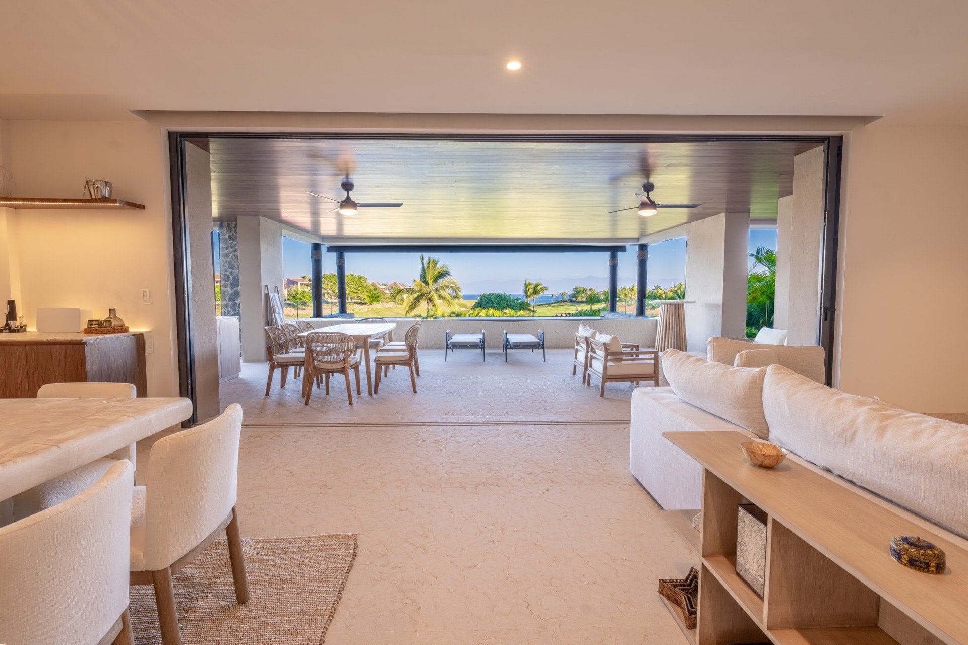 Condo Tau 612 living area opening to terrace dining and greenery — Punta Mita Nayarit, Mexico