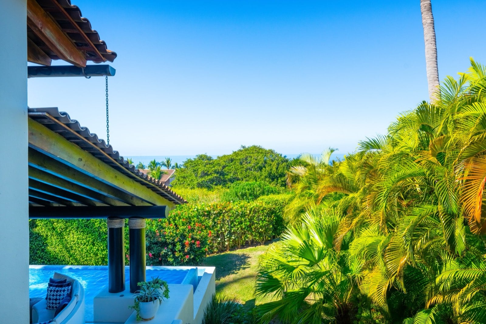 Four Seasons Villa 2037 exterior pool corner among palms with the sea beyond — Punta Mita Nayarit, Mexico