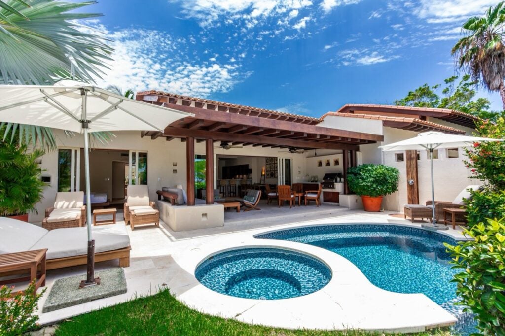 Villa Cazadores poolside terrace with lounge seating, dining area and round basin — Punta Mita Nayarit, Mexico