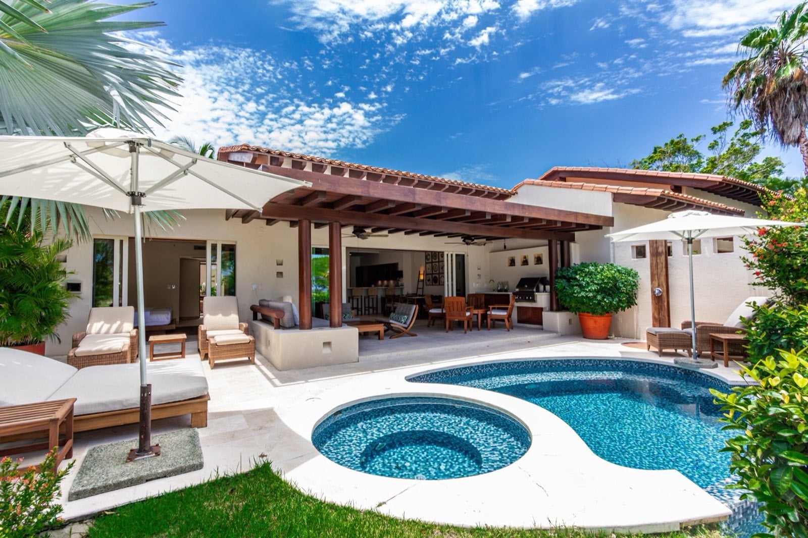 Villa Cazadores poolside terrace with lounge seating, dining area and round basin — Punta Mita Nayarit, Mexico
