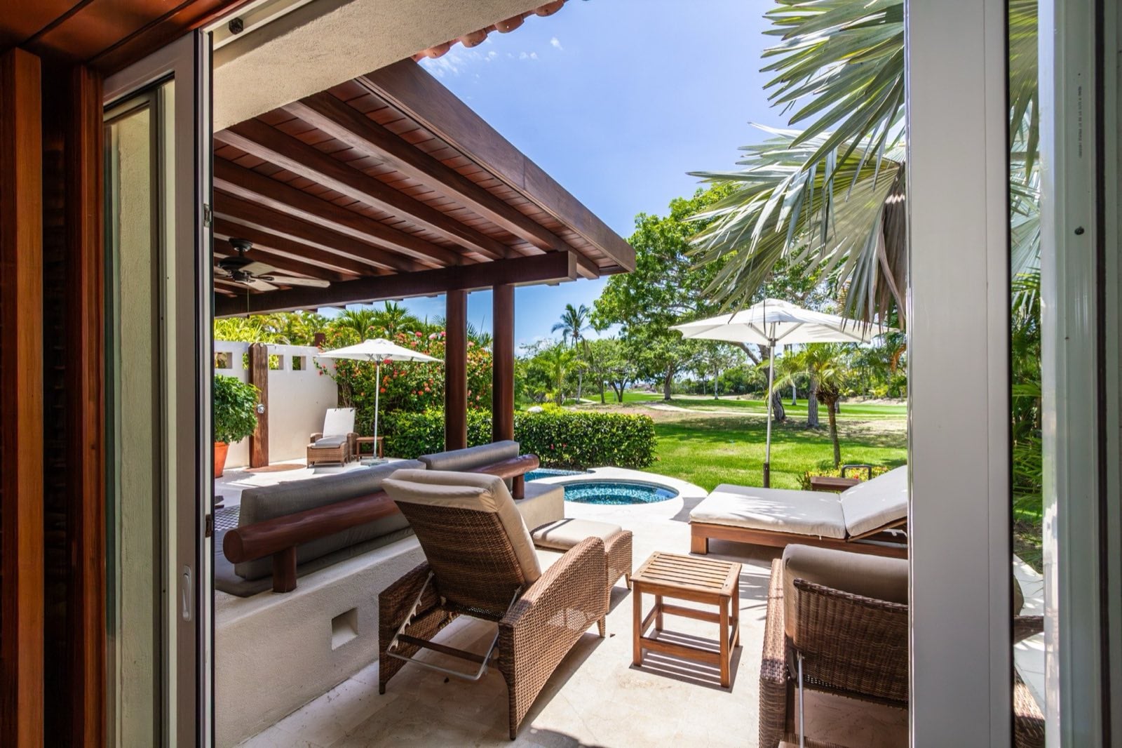 Villa Cazadores covered terrace and round pool basin viewed through open doors — Punta Mita Nayarit, Mexico
