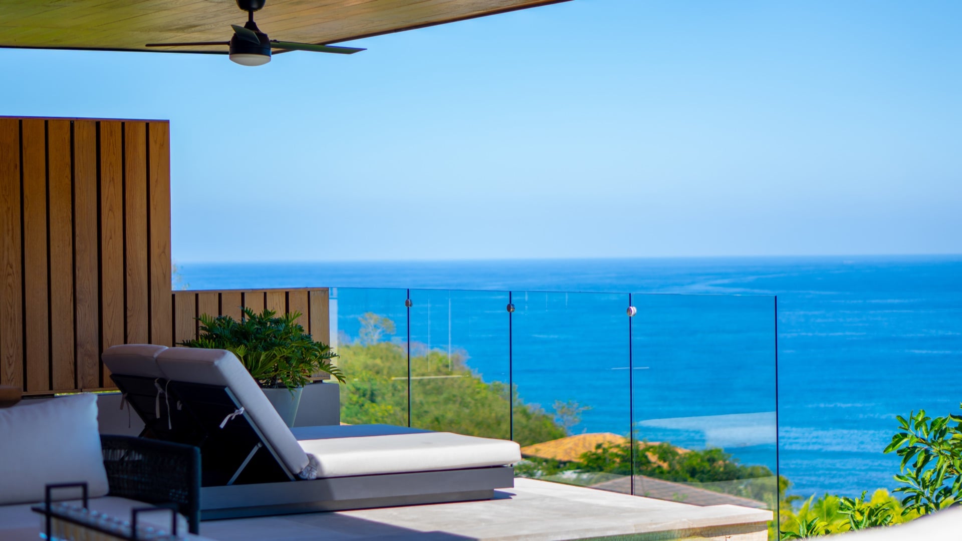Villa La Vista covered balcony with a lounger and ceiling fan above the bay — Punta Mita Nayarit, Mexico