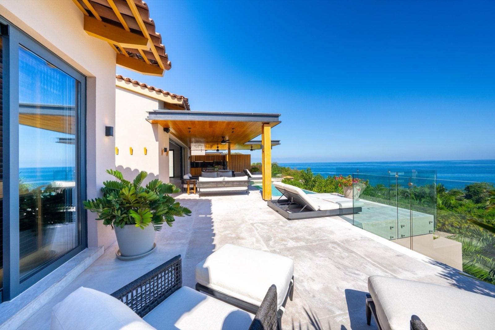 Villa La Vista terrace loungers and a potted plant facing the ocean — Punta Mita Nayarit, Mexico