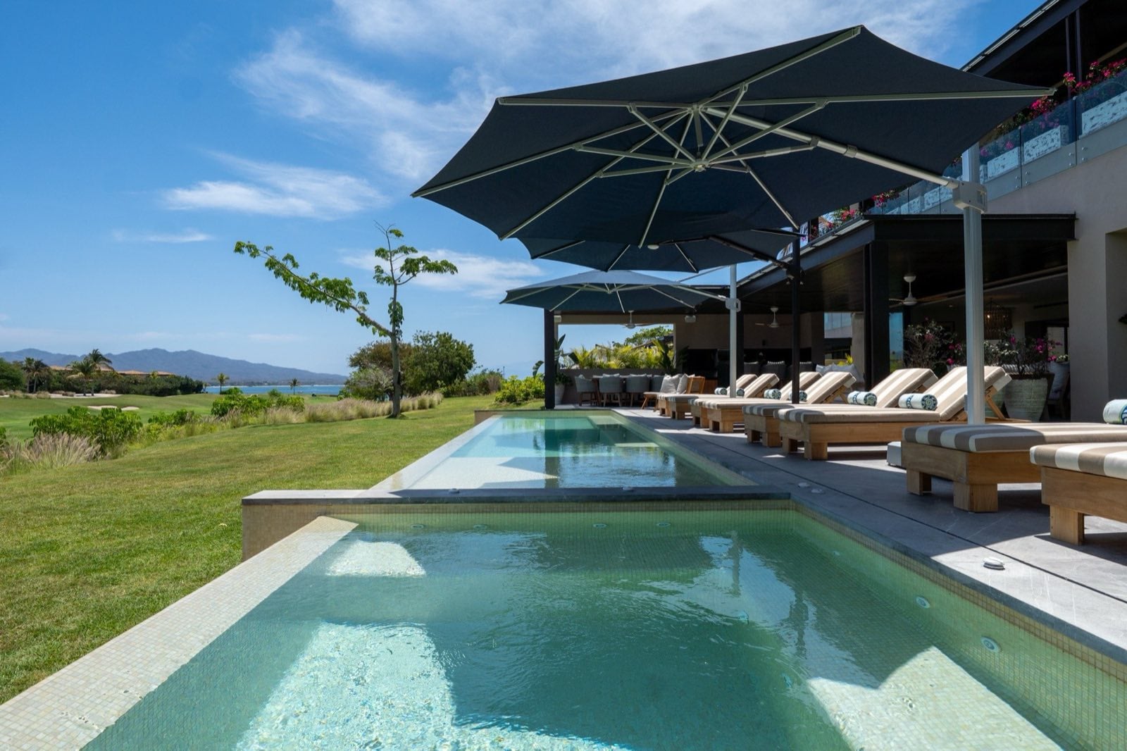 Villa Porta Fortuna 6 pool with shaded loungers beside landscaped grounds — Punta Mita Nayarit, Mexico