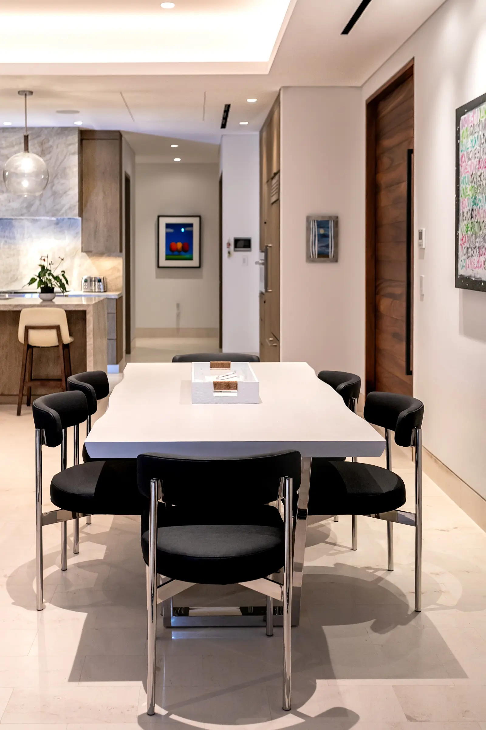 Bungalow 7 white dining table with black leather and chrome chairs — Los Cabos, Mexico