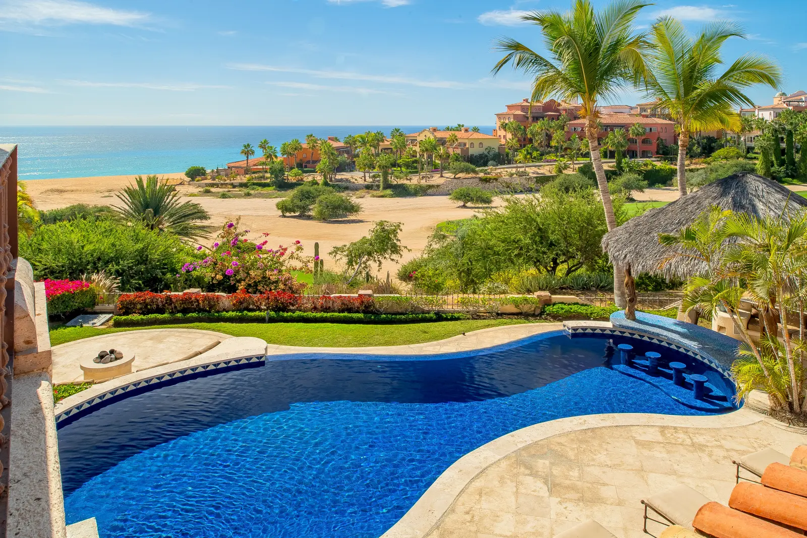 Casa Lolita blue-tiled pool with submerged stools at the swim-up counter — Los Cabos, Mexico