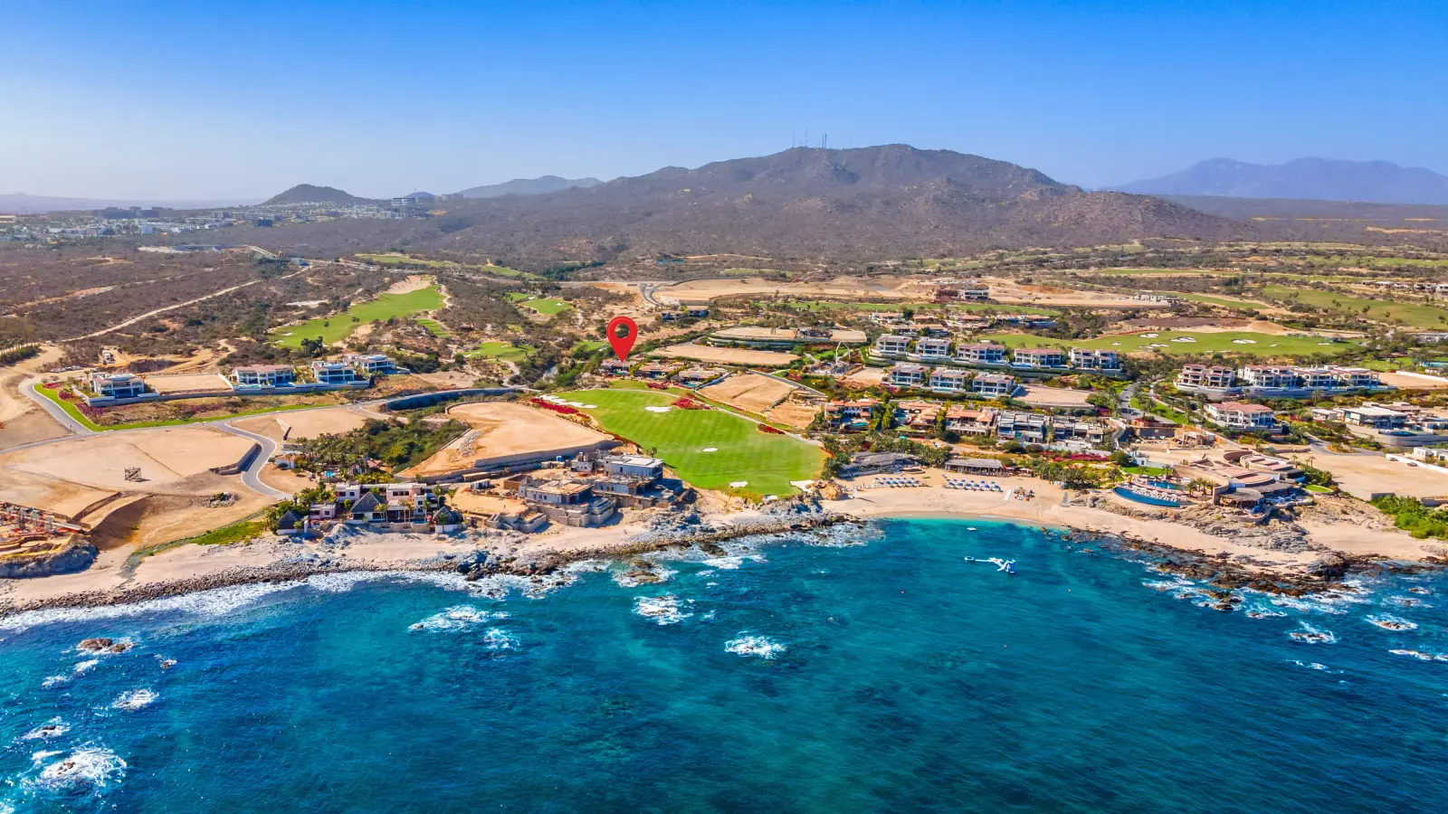 Casa Mar marked by a pin on the headland above a rocky bay and surf — Los Cabos, Mexico
