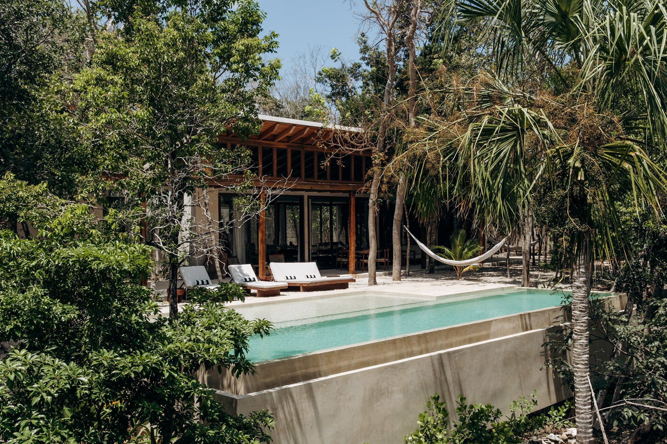Casa Tropical private pool with loungers and hammock amid jungle — Region 15 Tulum