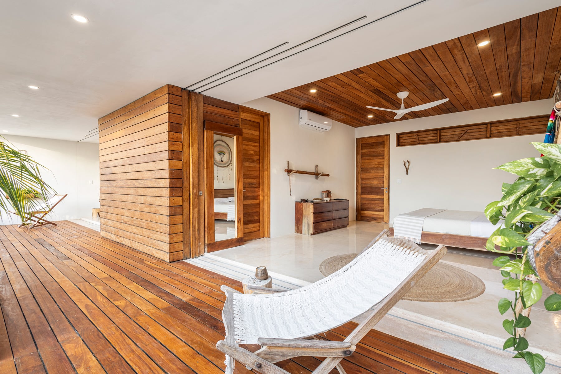 Casa Xixim covered terrace with a hanging chair and wood ceiling — Tulum, Mexico