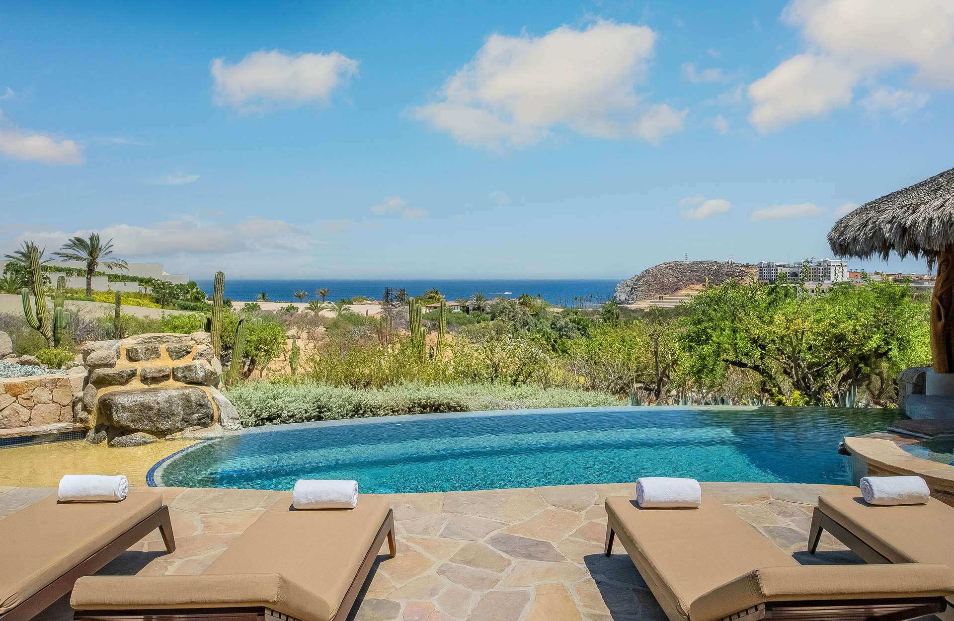 Villa Palmaritos 5 the pool's rock waterfall above the cactus garden and the bay — Los Cabos, Mexico