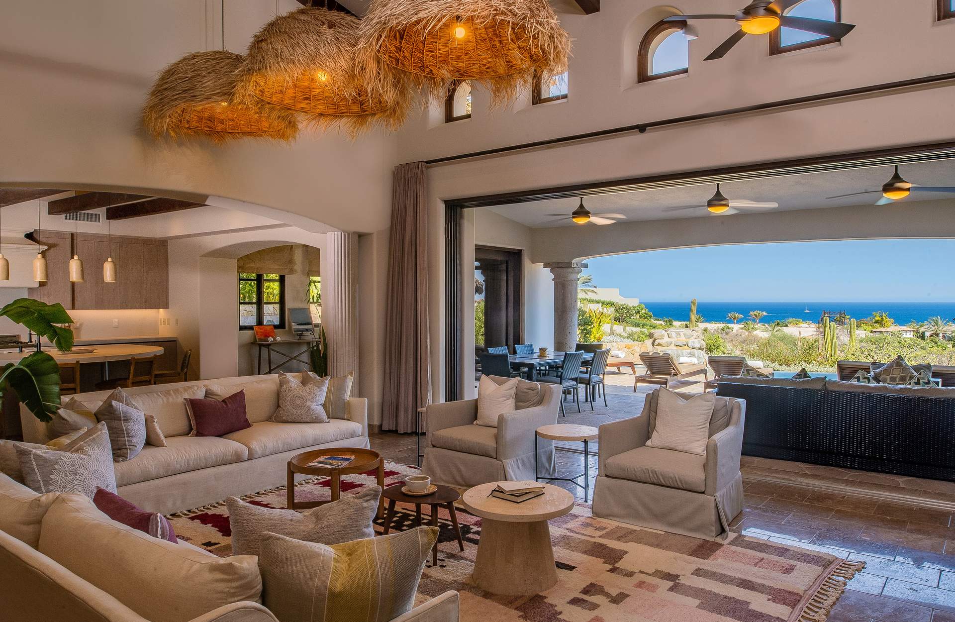 Villa Palmaritos 5 woven pendant shades above the sofas open to the terrace and sea — Los Cabos, Mexico