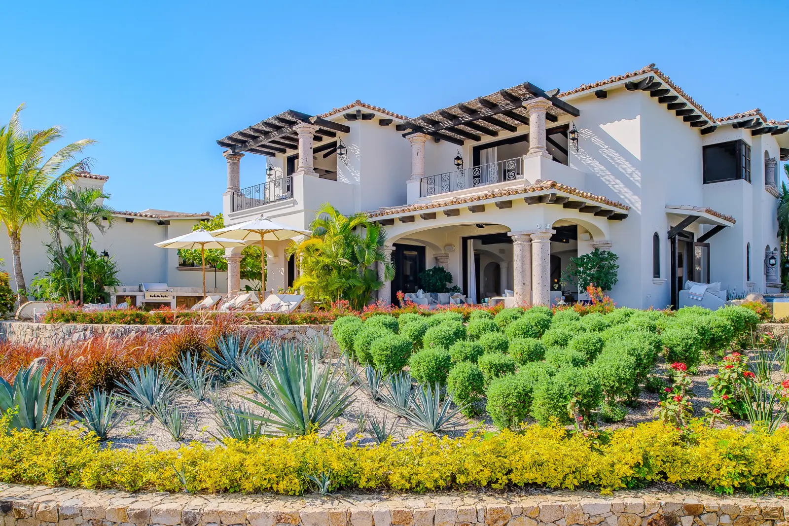 Villa Palmaritos 6 the full facade above clipped hedging and agaves — Los Cabos, Mexico