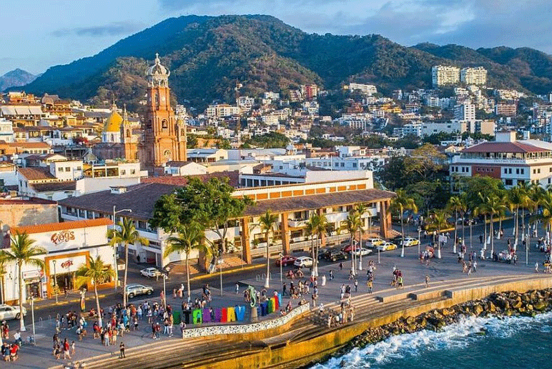 Puerto Vallarta Malecon boardwalk with sculptures and ocean views, a 45-minute day trip from Punta Mita