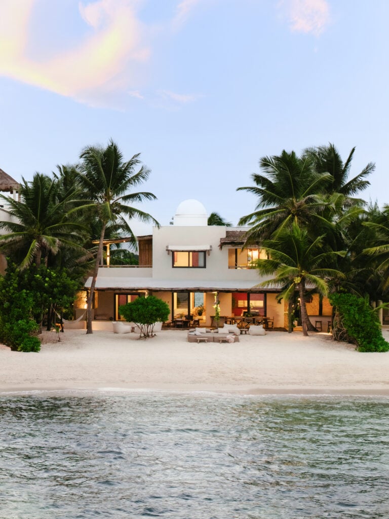 Villa Blanca ocean-view facade with loungers and palm trees at sunset — Tankah Bay Tulum