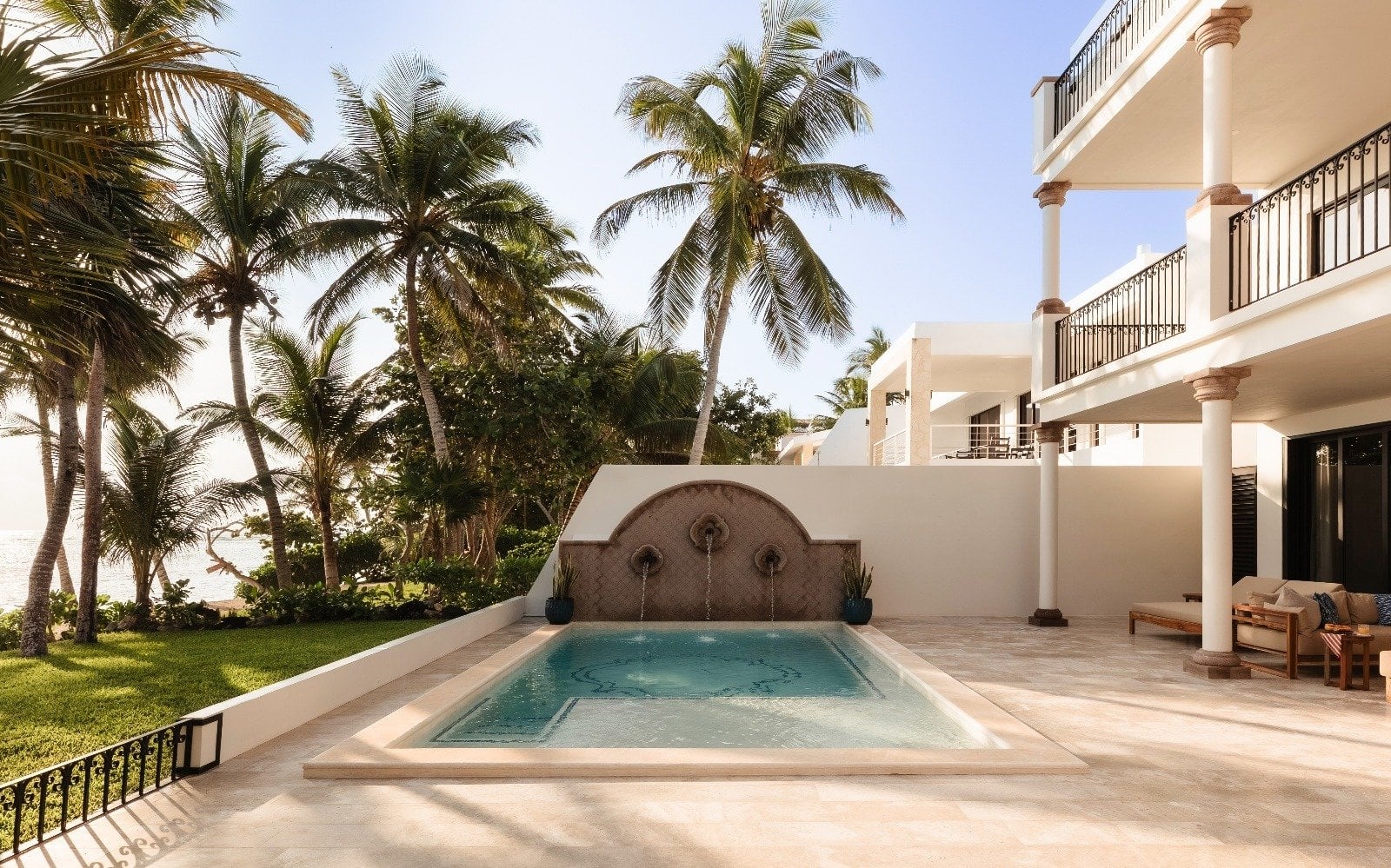 Villa Dulce Vida rectangular pool with three wall fountains and palm trees — Riviera Maya, Mexico