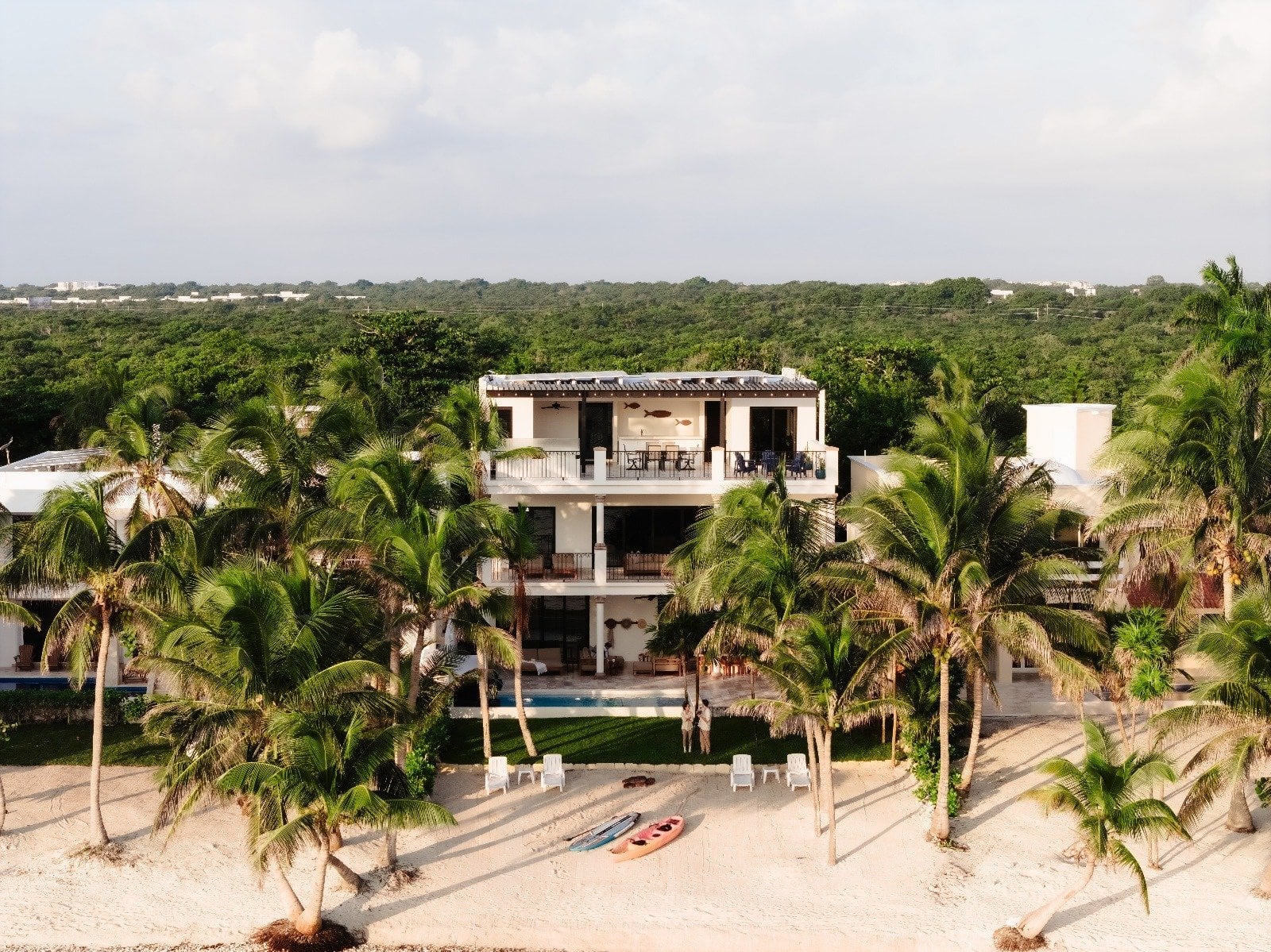 Villa Dulce Vida aerial view of the beachside villa and kayaks among palm trees — Riviera Maya, Mexico
