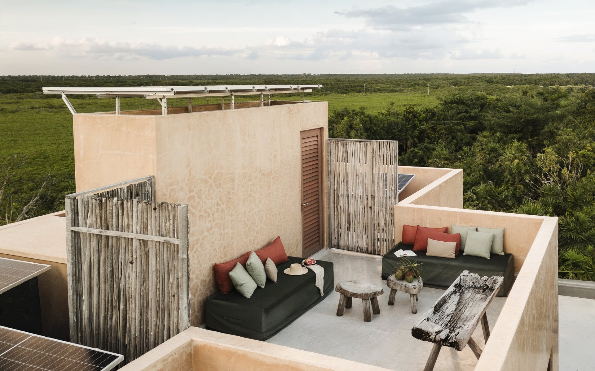 Villa Mariola rooftop lounge behind a wood privacy screen — Tulum, Mexico