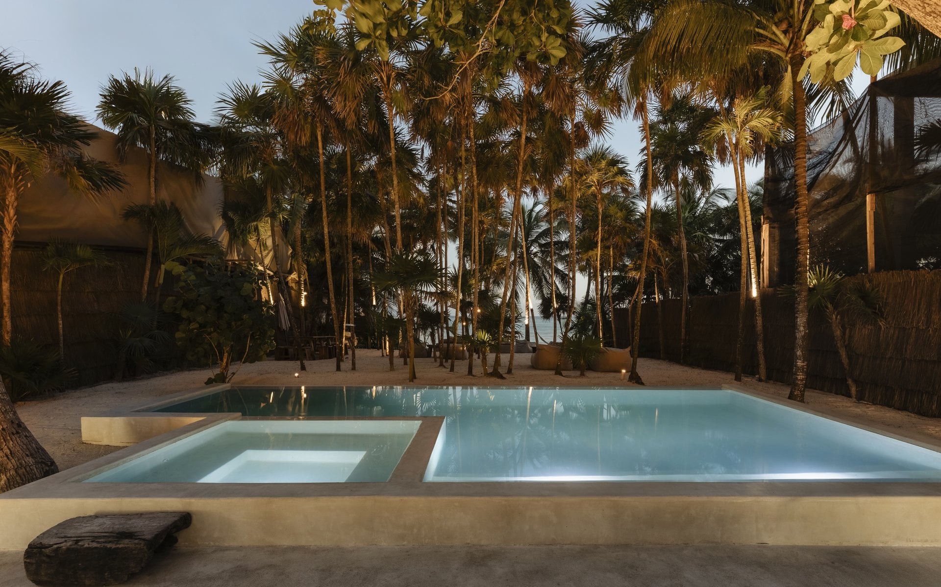 Villa Mariola swimming pool with a raised spa under palms — Tulum, Mexico