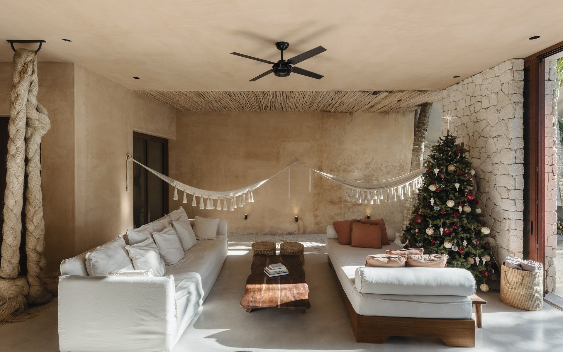 Villa Mariola living room with white sofas and a hammock by the garden — Tulum, Mexico