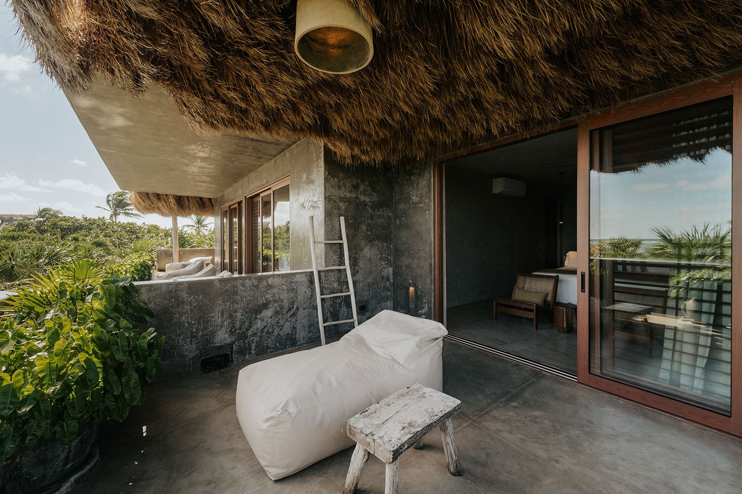 Villa Moloch upper floor terrace with bean bag lounger under palapa roof — Soliman Bay Tulum
