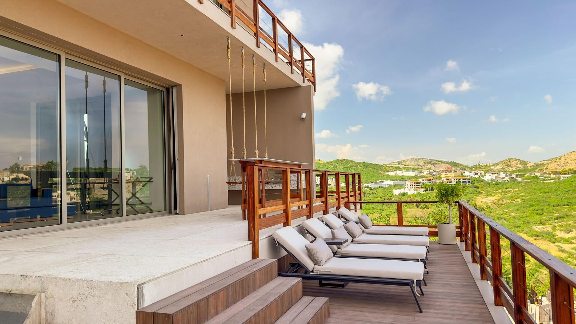 Villa Solara deck with a row of sun loungers and ocean view — Los Cabos, Mexico