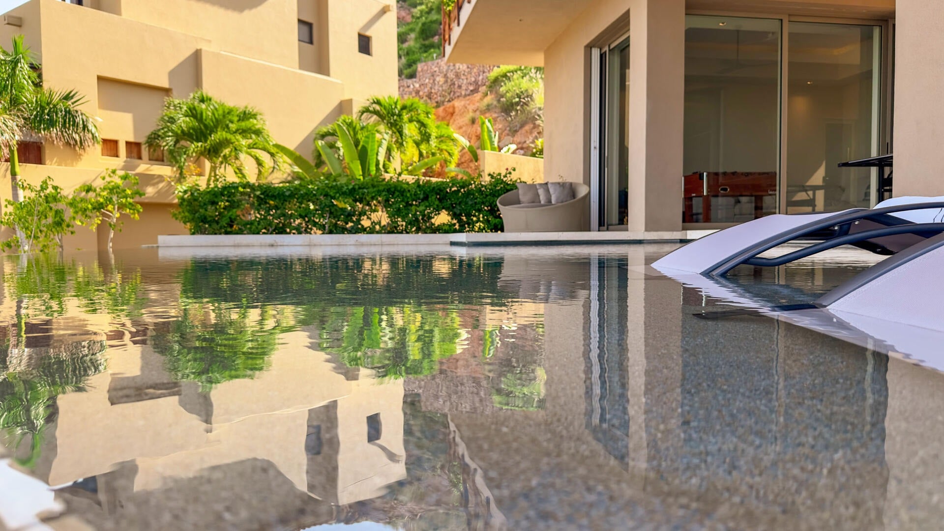 Villa Solara swimming pool beside the garden and villa facade — Los Cabos, Mexico