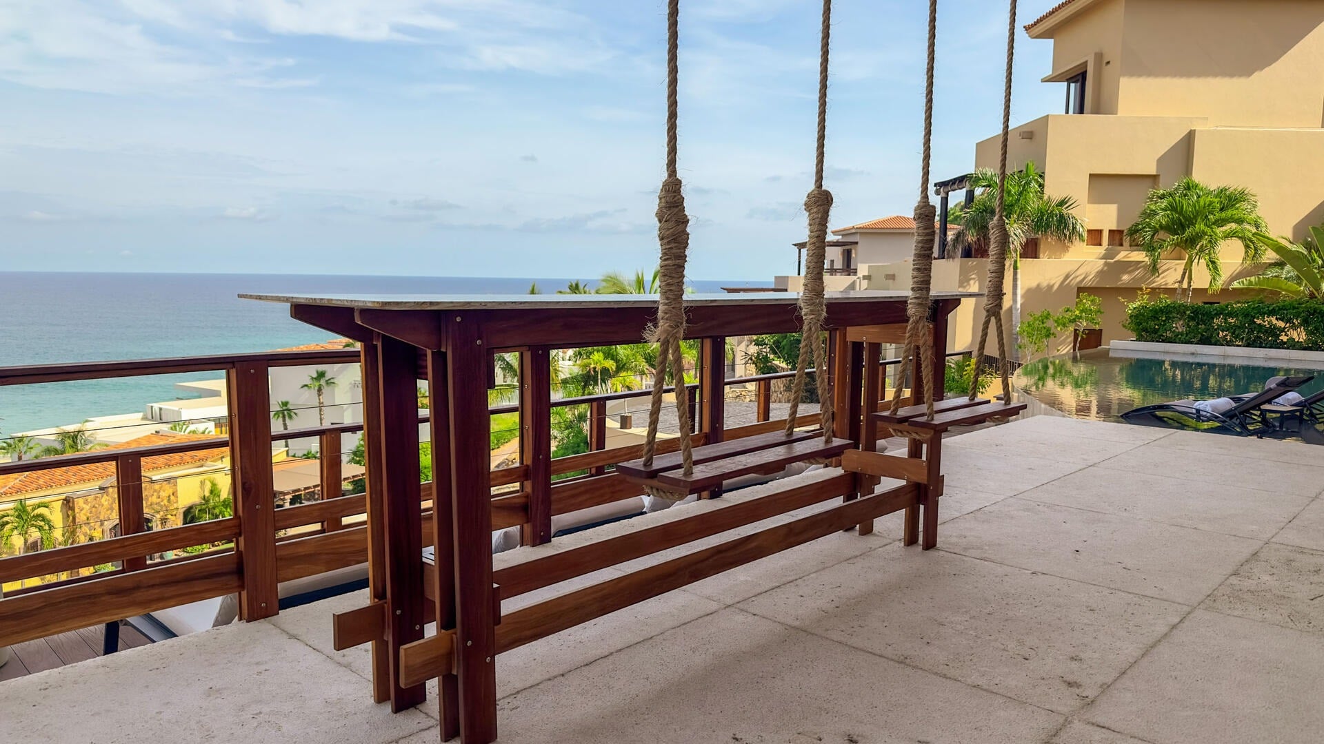 Villa Solara terrace with hanging bench seats and an ocean view — Los Cabos, Mexico