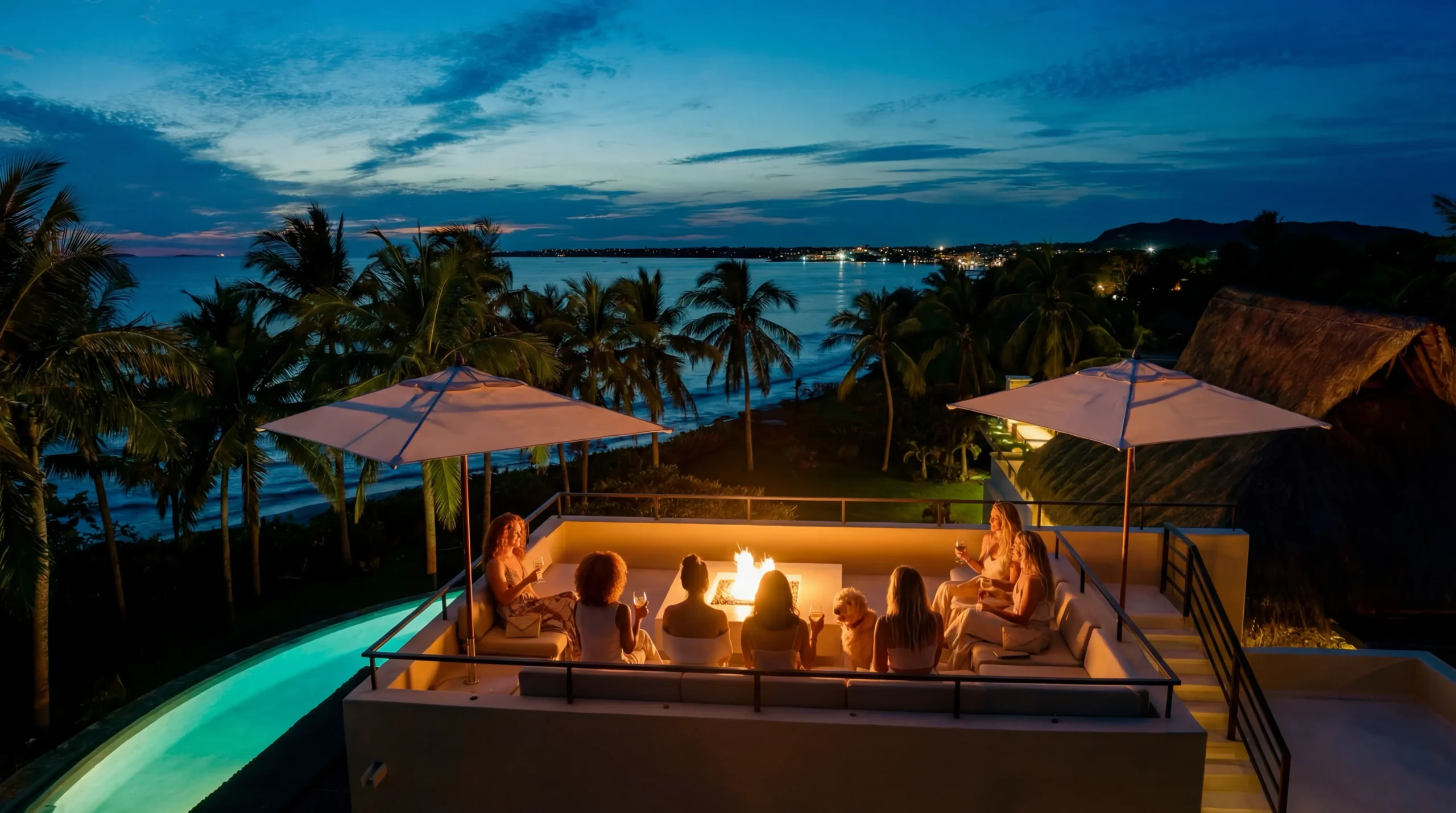 Casa Happy Paws group seated around a rooftop fire pit at dusk — Punta Mita Nayarit, Mexico