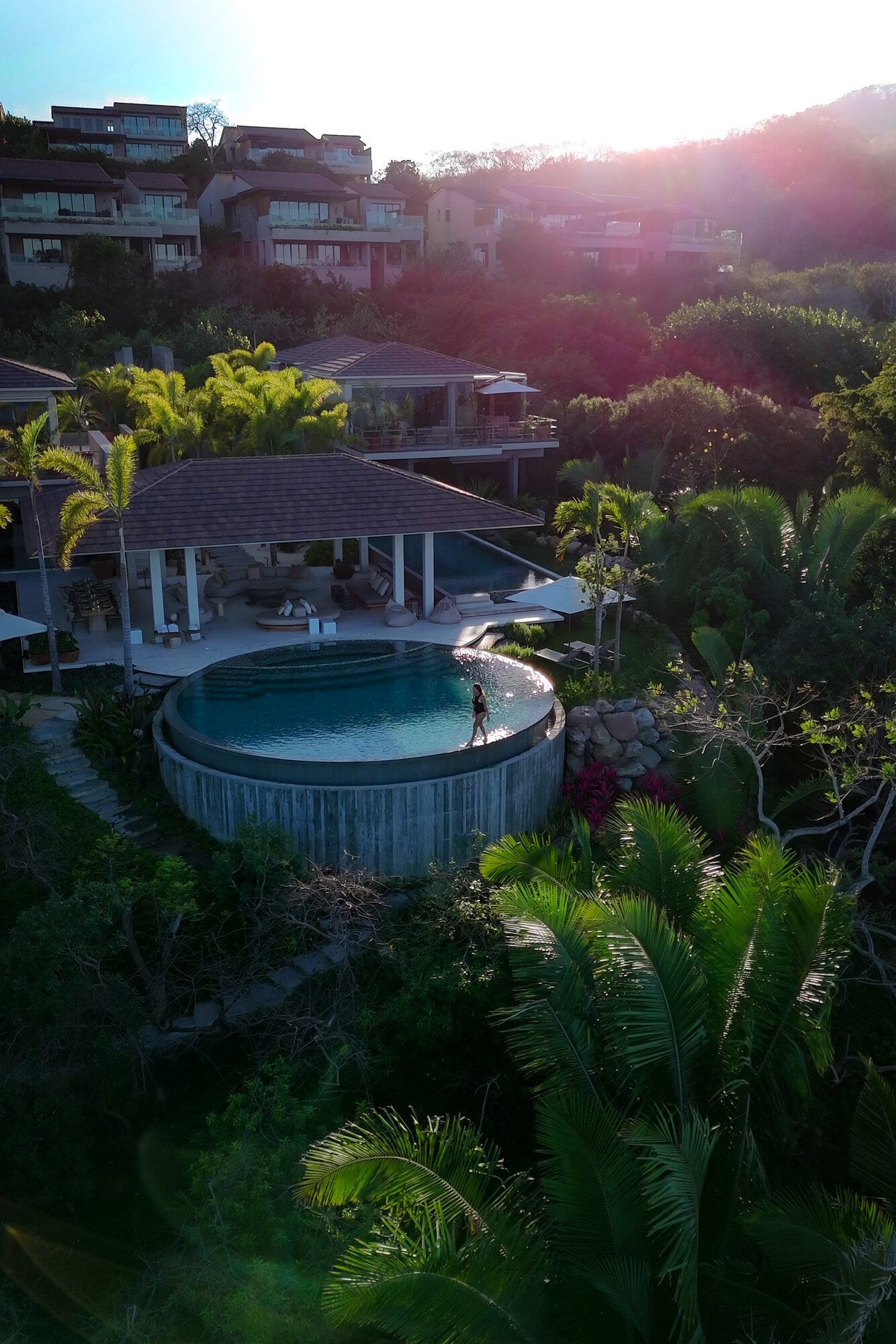 Casa Koko Iyari aerial of a person standing in a round pool below an open pavilion — Punta Mita Nayarit, Mexico