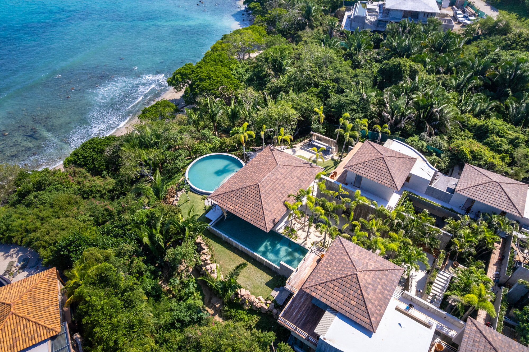 Casa Koko Iyari aerial of tiled roofs and two pools beside the coast — Punta Mita Nayarit, Mexico