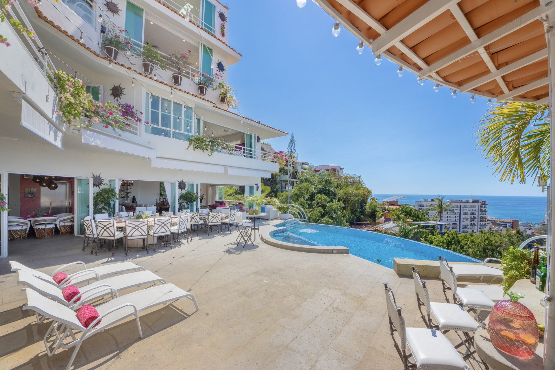 Villa Yvonneka poolside sun deck with loungers and ocean view — Puerto Vallarta, Mexico