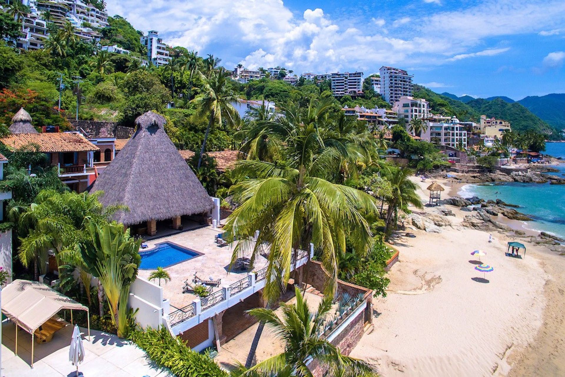 Villa Verde pool terrace and thatched roof beside the beach — Puerto Vallarta, Mexico