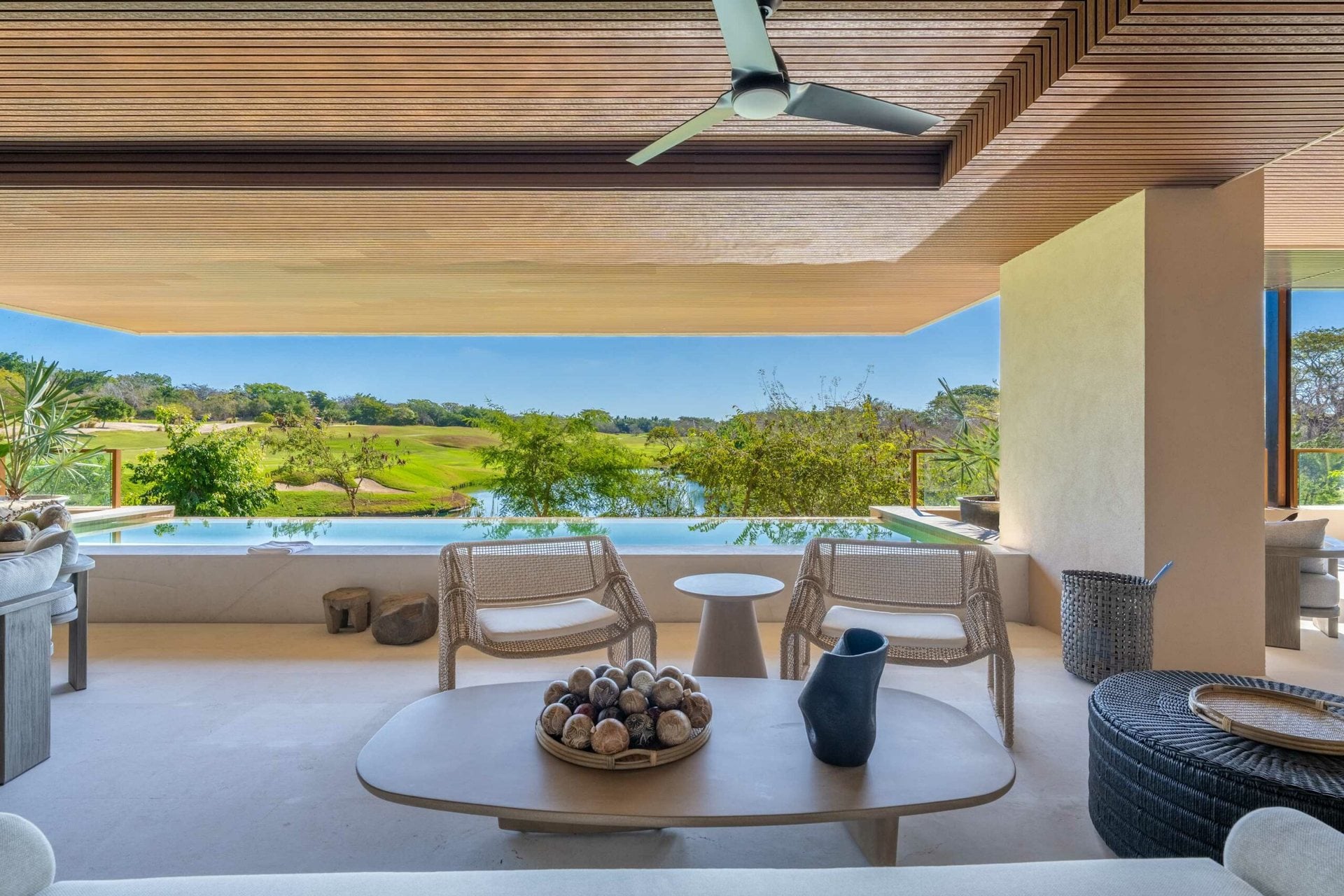 Condo 7 Eight 301 covered terrace seating facing golf greens and a pond — Punta Mita Nayarit, Mexico