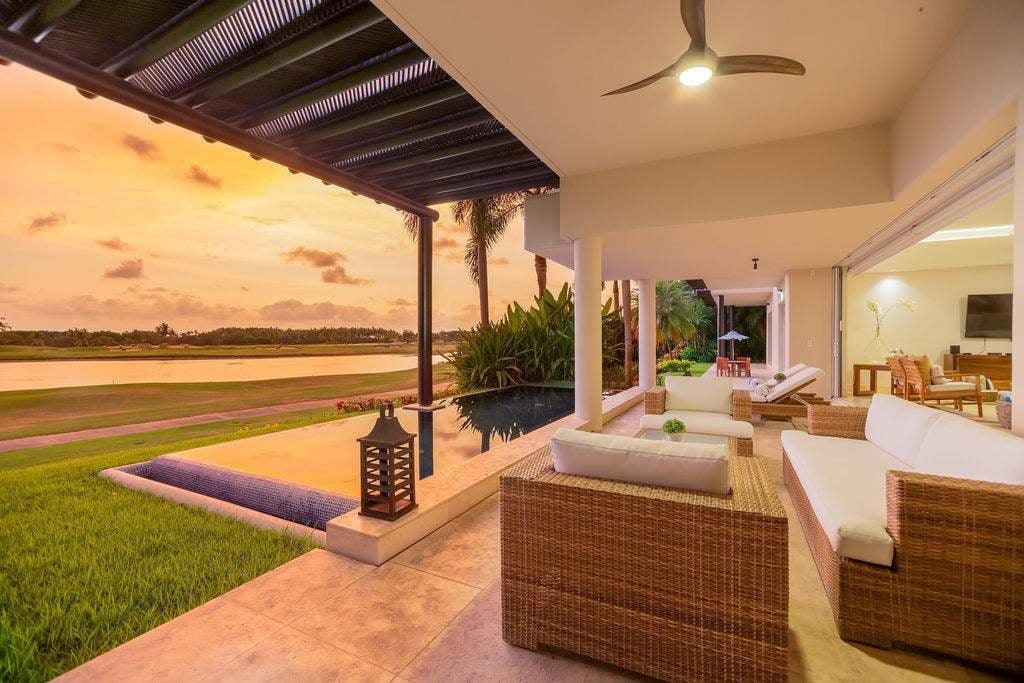 Condo El Encanto 601 covered patio seating beside the pool at sunset — Punta Mita Nayarit, Mexico