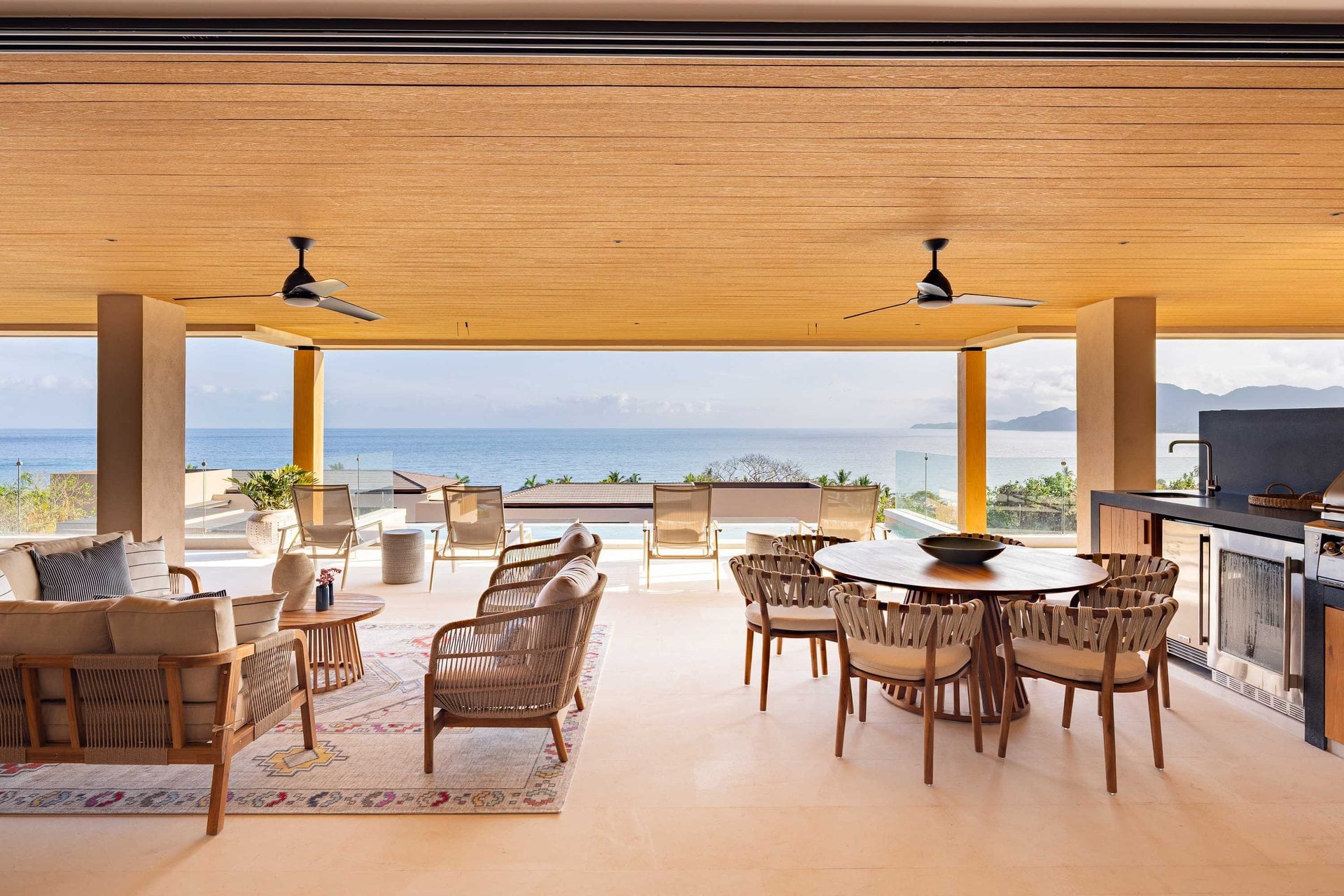 Kupuri 401 covered terrace with dining and lounge seating overlooking the ocean — Punta Mita Nayarit, Mexico